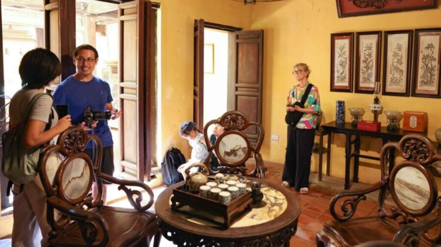Tourists are contemplating and stepping back in time in the ancient setting of the old house.