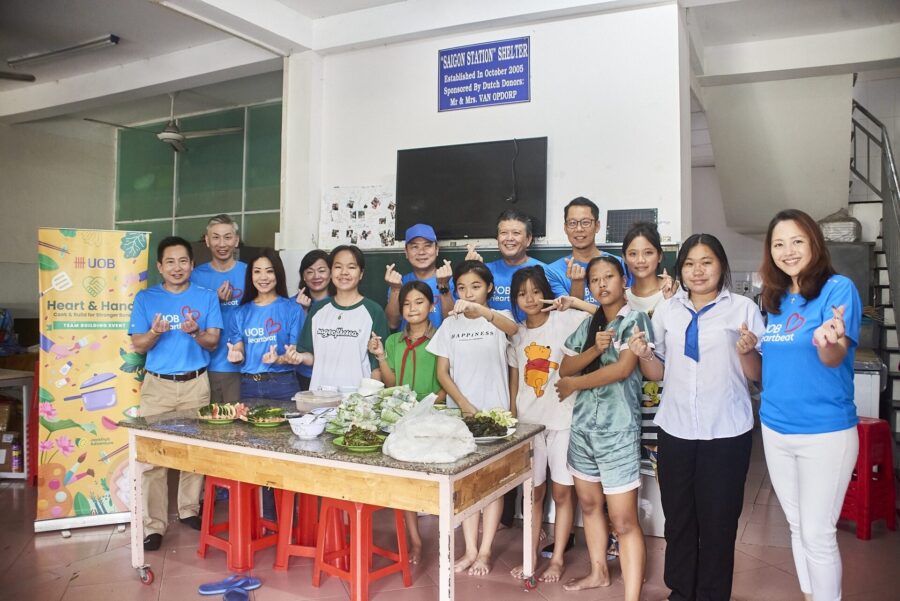 Corporate team cooking for a cause during a CSR problem-solving activity in Vietnam