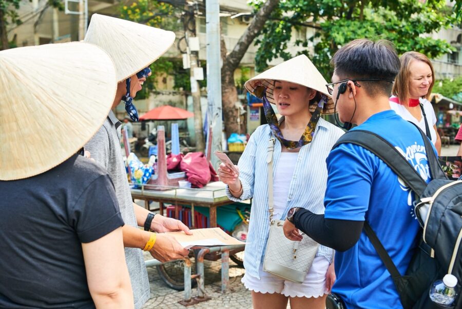 Corporate teams joining a city quest problem-solving activity in Vietnam