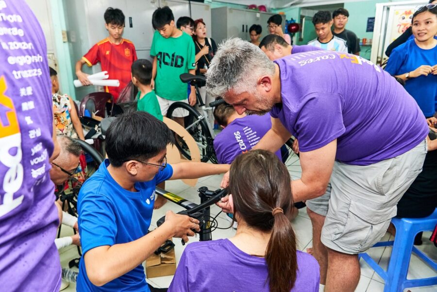 Corporate team building bicycles during a problem-solving activity in Vietnam