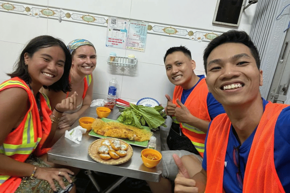 Travelers and local guides share bánh xèo during a food stop on one day in Ho Chi Minh City - Jackfruit 