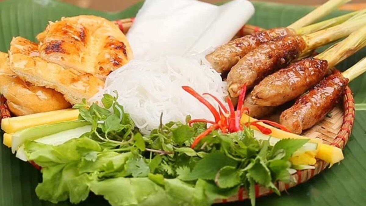 nem lụi with grilled pork skewers, rice paper, herbs, and dipping sauce - hue food - Jackfruit