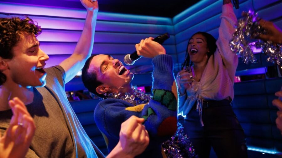 Friends singing and dancing in a colorful private room for karaoke in Ho Chi Minh City _ Jackfruit
