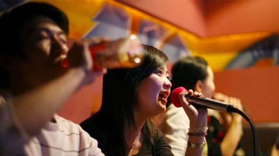 Woman singing into a microphone during karaoke in Ho Chi Minh City_ Jackfruit