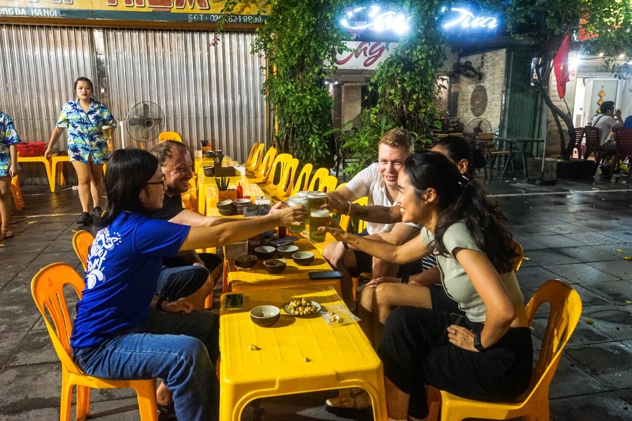 Guide leading a Hanoi foodie cycling tour through the Old Quarter with Jackfruit Adventure