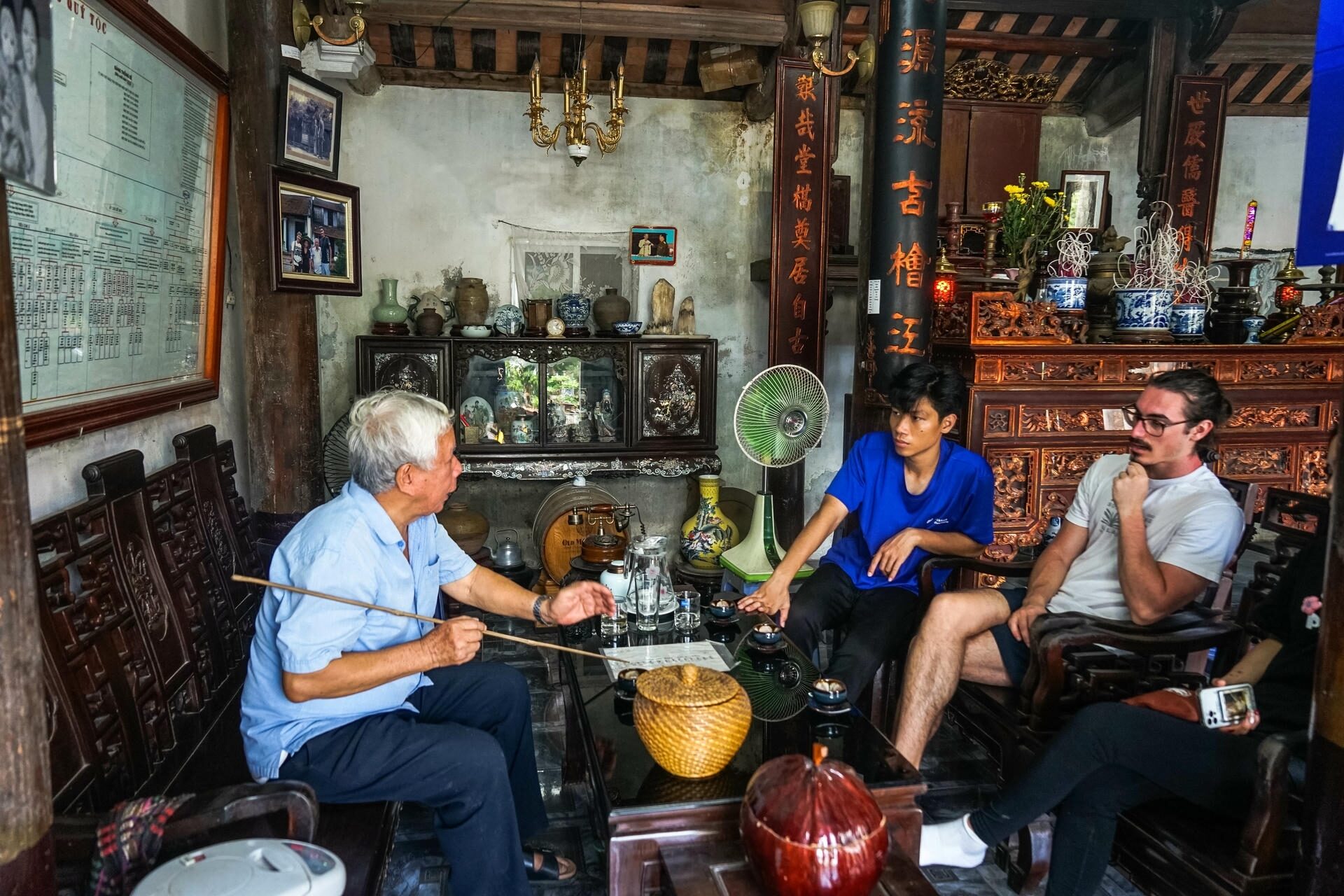 A local vendor chatting with tourists in Vietnam, where English and the Vietnam language meet, explored with Jackfruit Adventure
